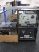 A stereo cabinet containing Realistic 3 Speed Stereo Tape Deck and TR 3000 Logic Control,