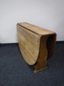 An antique pine drop leaf table