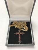A 9ct gold flat linked necklace, 17.9g, together with a 9ct gold garnet set crucifix pendant.