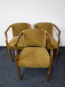 A set of three armchairs upholstered in a gold dralon