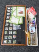 A display case and a box containing a quantity of collector's pins