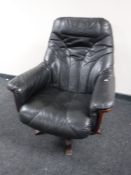 A black leather swivel adjustable armchair