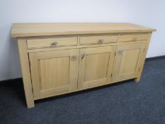 A contemporary triple door sideboard fitted three drawers