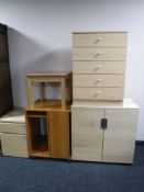 A pine effect five drawer chest, together with a revolving book stand, coffee table,