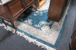 A green embossed fringed Chinese rug