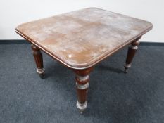 A Victorian mahogany wind out table with two leaves