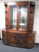 An inlaid mahogany double door bookcase, fitted cupboards and drawers beneath,