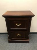 A contemporary mahogany two drawer filing chest with brass drop handles