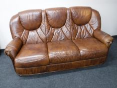 A brown leather three seater settee