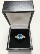 A 9ct gold dress ring set with a blue stone, size S/T.