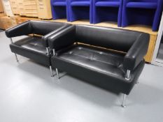 A pair of black leather Edge reception settees and a glass topped coffee table