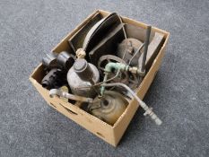 A box containing vintage oil lamps together with a brass Primus stove