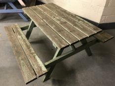 A fixed position wooden table and bench set,