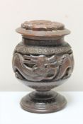 An oriental carved hardwood lidded spice jar