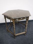 A hexagonal oak occasional table on barley twist legs,