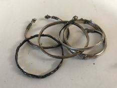 Five silver / white metal bangles.