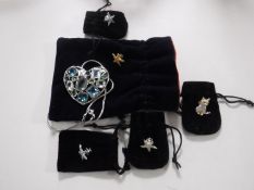 A Swarovski necklace and five Swarovski pin badges, all with velvet bags.