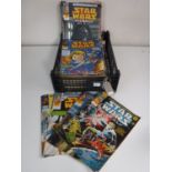 A basket of 1970's and later Star Wars Weekly comics