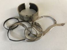 Five silver / white metal bangles and part bangles.