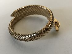 An 18ct gold snake bracelet with ruby eyes, 36.8g gross.