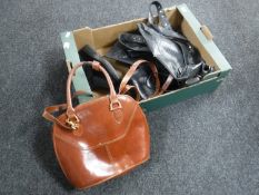 A box containing assorted leather handbags
