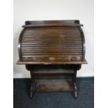 An early 20th century oak roll front bureau