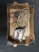 A box of six metal croquet hoops and four balls,