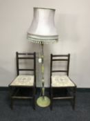 A pair of Edwardian oak bedroom chairs together with a standard lamp and shade