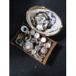 A box and a basket of continental figures, Staffordshire dog, wall plaques, tea china,