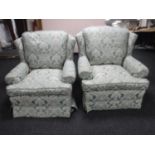 A pair of armchairs upholstered in a green classical fabric