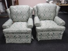 A pair of armchairs upholstered in a green classical fabric