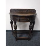 A heavily carved early 20th century oak hall table CONDITION REPORT: The top is not
