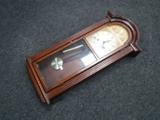 An Actim 31 day wall clock with pendulum,