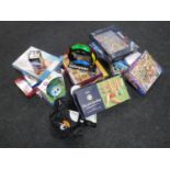 A box of assorted jigsaws and games