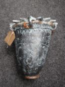An Eastern style pottery vase with sunburst rim