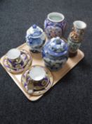 A tray of Oriental wares to include two Meito china trios, blue and white lidded jars,