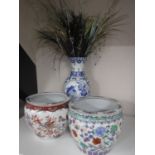 Two oriental fish bowl planters and an blue and white vase with bird decoration containing dried