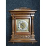 An Edwardian oak bracket clock