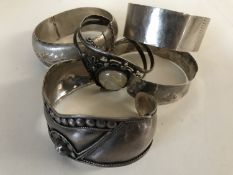 Five silver / white metal bangles.