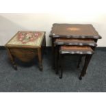 A nest of three inlaid mahogany tables and a commode