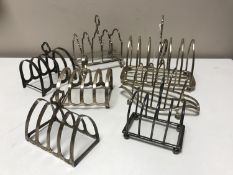 Seven antique silver toast racks