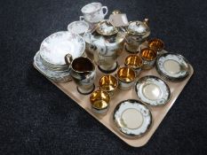 A tray containing a fifteen-piece Oriental style gilded tea service together with seventeen pieces