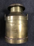 An antique brass lidded churn