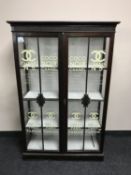 An early 20th century mahogany double door bookcase bearing perfume advertising