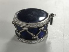 An enamelled white metal pill box, possibly Russian, in the form of a drum.