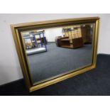 A black and gilt framed bevel edge mirror