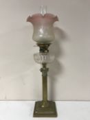 A Victorian glass oil lamp with clear glass reservoir CONDITION REPORT: Shade with