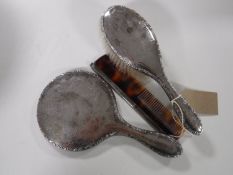 A sterling silver back hand brush, hand mirror and a comb (3).
