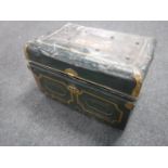 A vintage tin trunk containing cushions