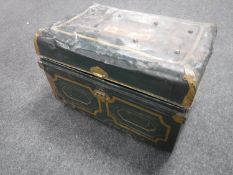 A vintage tin trunk containing cushions